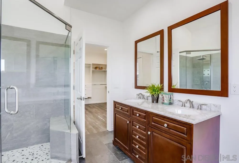 39431 American Road Fallbrook, CA 92028 - Photo 30 of 62 a bathroom with a granite countertop sink mirror and a shower