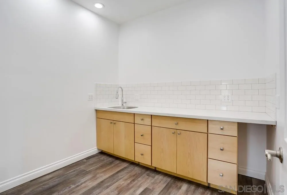 39431 American Road Fallbrook, CA 92028 - Photo 41 of 62 a room with white cabinets and wooden floors