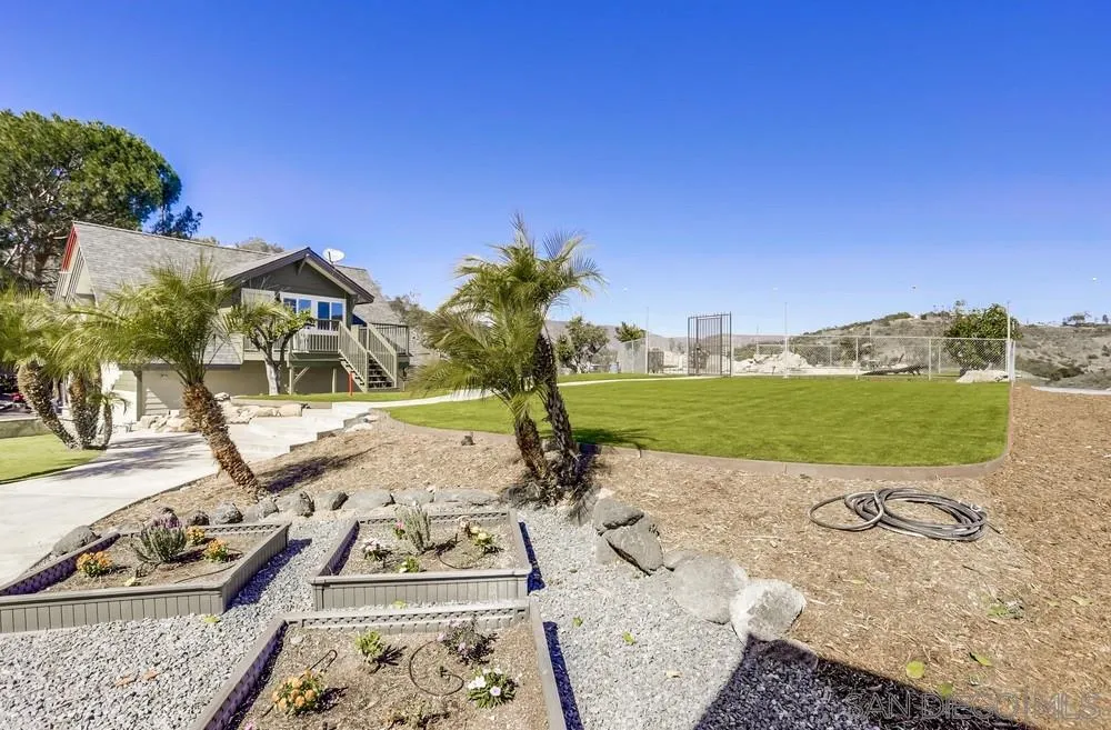 39431 American Road Fallbrook, CA 92028 - Photo 45 of 62 a view of a swimming pool with a yard and potted plants