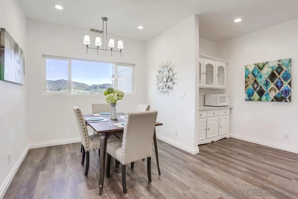 39431 American Road Fallbrook, CA 92028 - Photo 10 of 62 a view of a dining room with furniture a chandelier and wooden floor