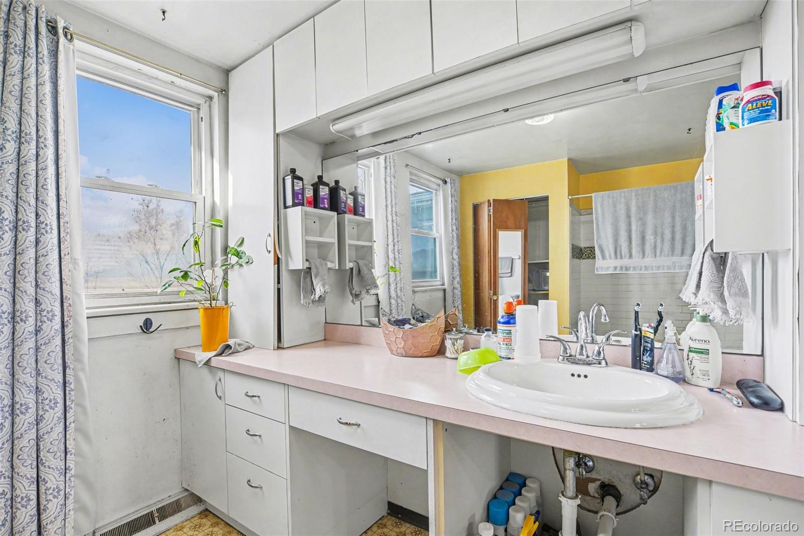 901 County Road 3 Wiggins, CO 80654 - Photo 15 of 28 a bathroom with a sink double vanity and a mirror