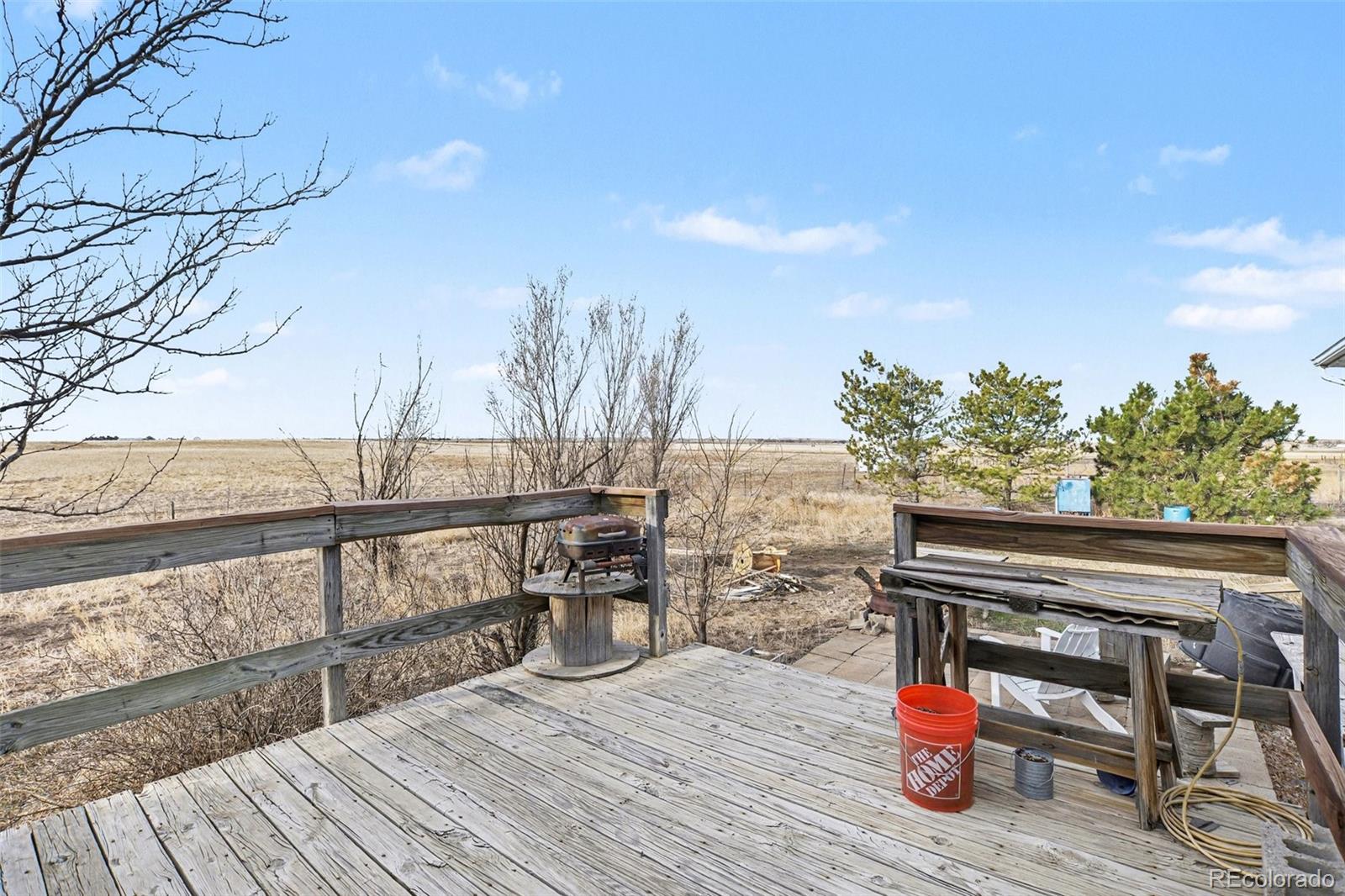 901 County Road 3 Wiggins, CO 80654 - Photo 17 of 28 a view of a terrace with furniture and trees