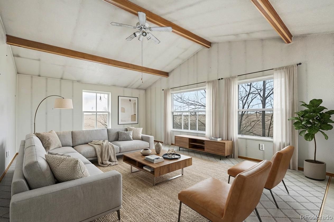 901 County Road 3 Wiggins, CO 80654 - Photo 5 of 28 a living room with furniture and a large window
