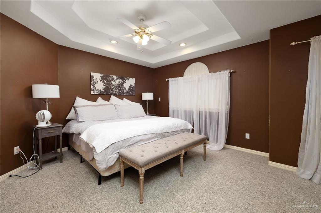 23725 North Val Verde Road Edinburg, TX 78542 - Photo 24 of 36 a bedroom with a bed and a chandelier