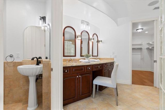 a spacious bathroom with a granite countertop sink a toilet and shower