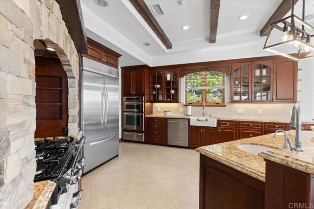 a dining room with furniture a chandelier and wooden floor