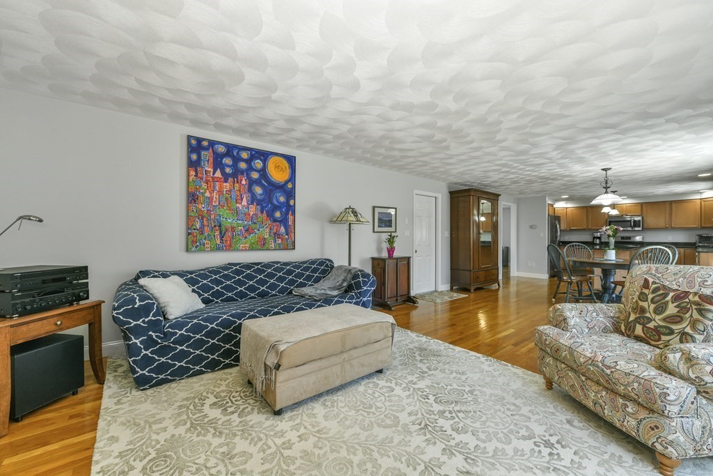 211 Pearl Street Reading, MA 01867 - Photo 14 of 34 a living room with furniture and a painting on the wall