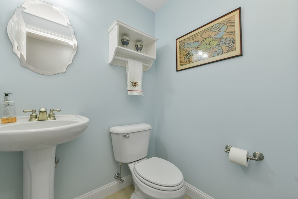 211 Pearl Street Reading, MA 01867 - Photo 17 of 34 a bathroom with a toilet sink and mirror