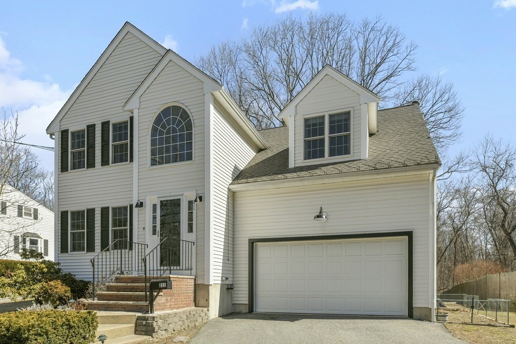 211 Pearl Street Reading, MA 01867 - Photo 2 of 34 a front view of a house with a garage