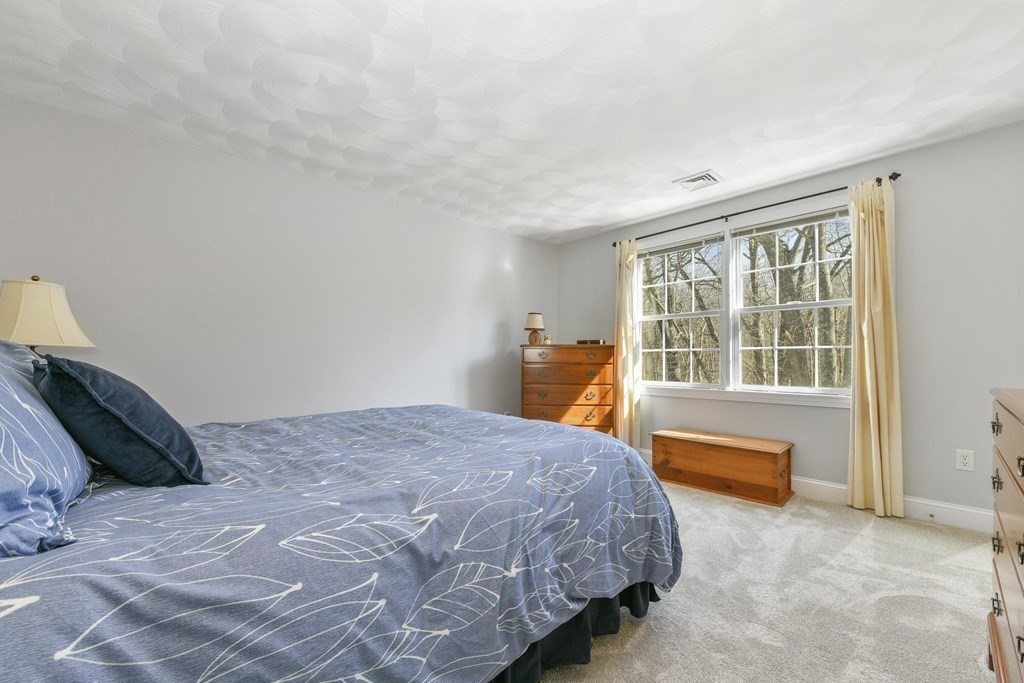 211 Pearl Street Reading, MA 01867 - Photo 21 of 34 a bedroom with a bed and a large window