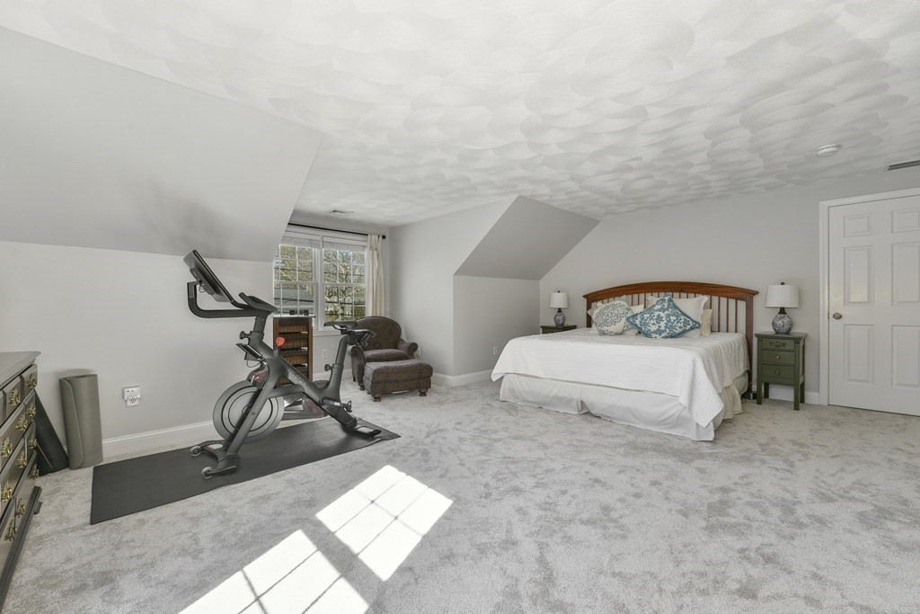 211 Pearl Street Reading, MA 01867 - Photo 25 of 34 a bedroom with a bed a table and chair