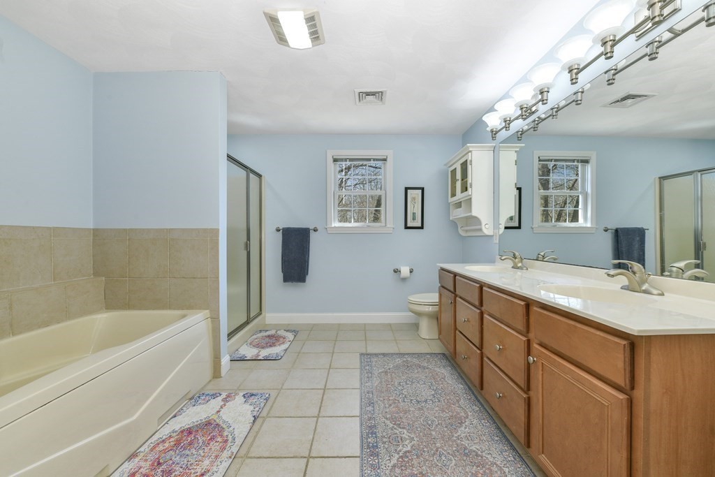 211 Pearl Street Reading, MA 01867 - Photo 26 of 34 a spacious bathroom with a tub sink and mirror