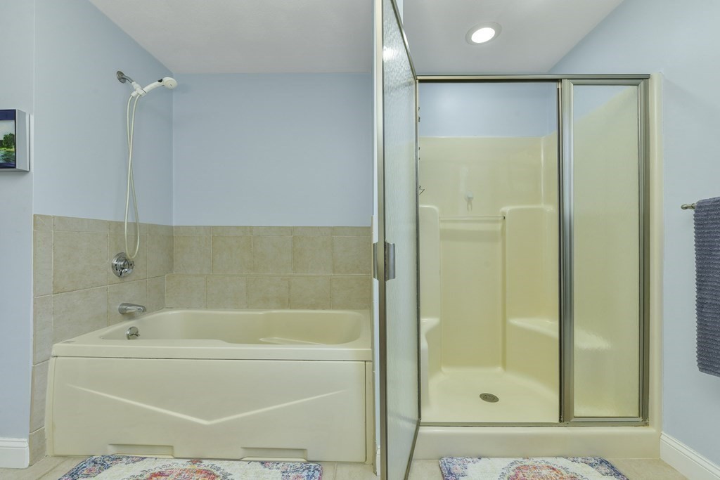 211 Pearl Street Reading, MA 01867 - Photo 27 of 34 a bathroom with a bathtub and a shower