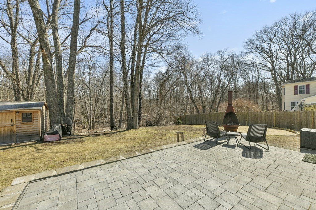 211 Pearl Street Reading, MA 01867 - Photo 28 of 34 a backyard of a house with table and chairs