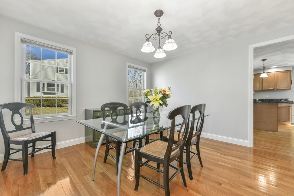 211 Pearl Street Reading, MA 01867 - Photo 8 of 34 a view of a dining room with furniture and wooden floor