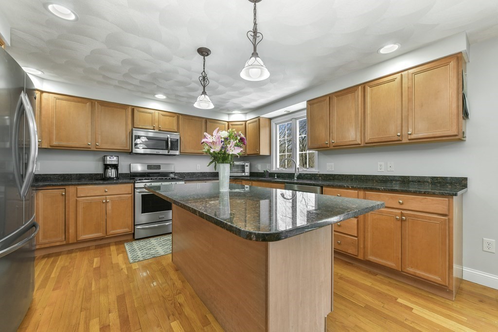 211 Pearl Street Reading, MA 01867 - Photo 10 of 34 a kitchen with stainless steel appliances granite countertop a sink a stove and a microwave