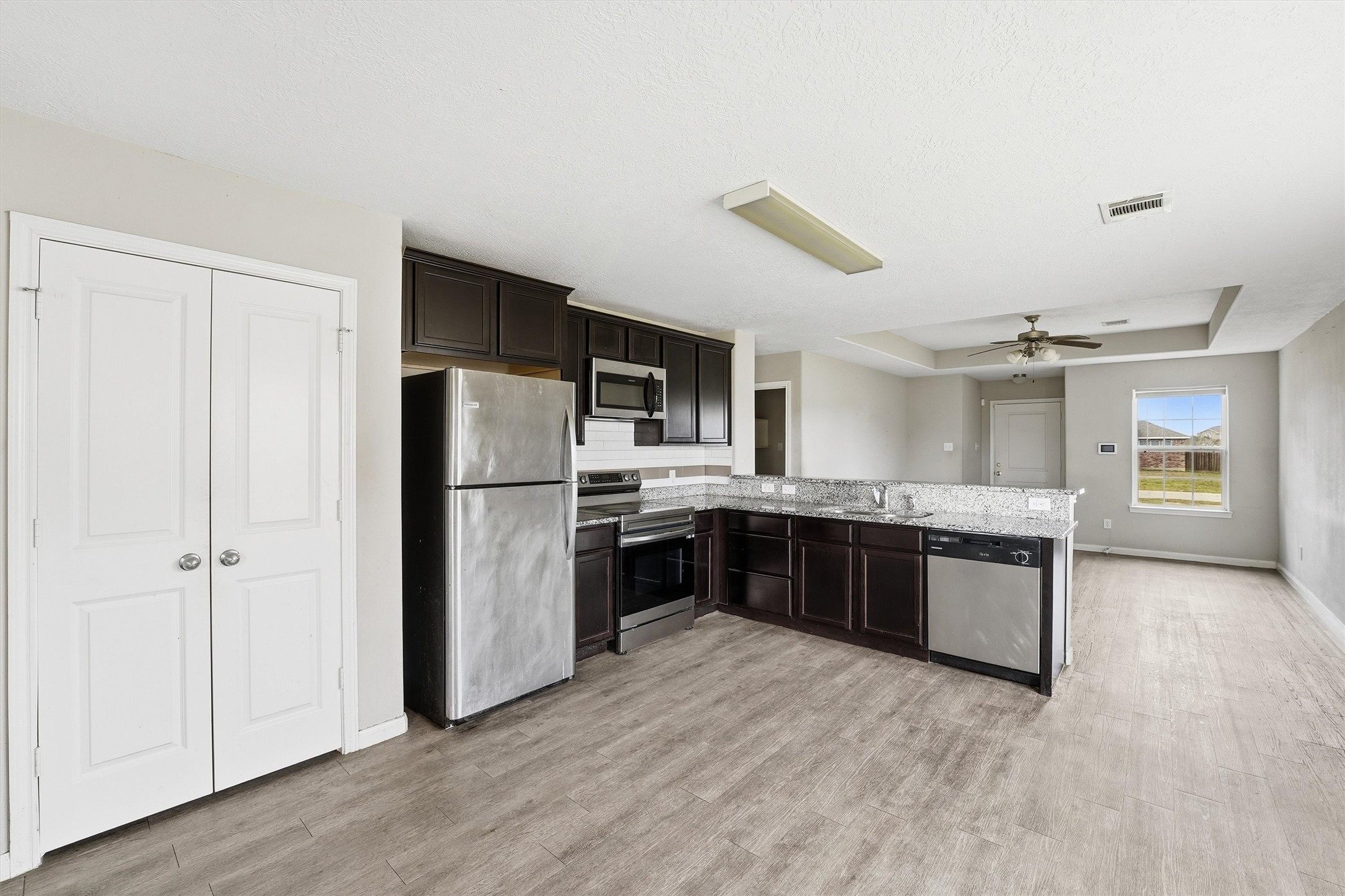 47 Road 5103 Cleveland, TX 77327 - Photo 12 of 33 a large kitchen with a refrigerator and a stove top oven