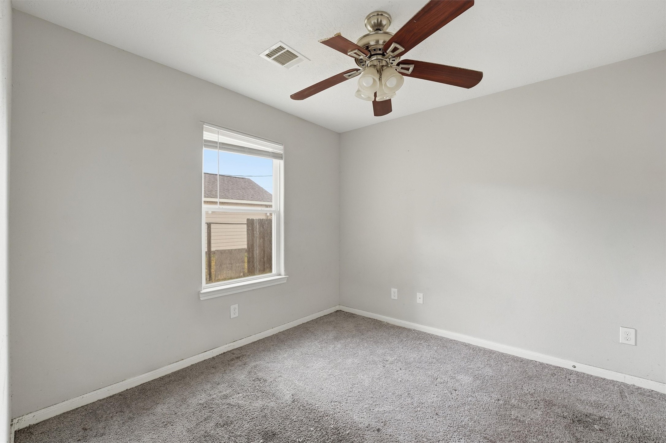 47 Road 5103 Cleveland, TX 77327 - Photo 18 of 33 an empty room with a window and a fan