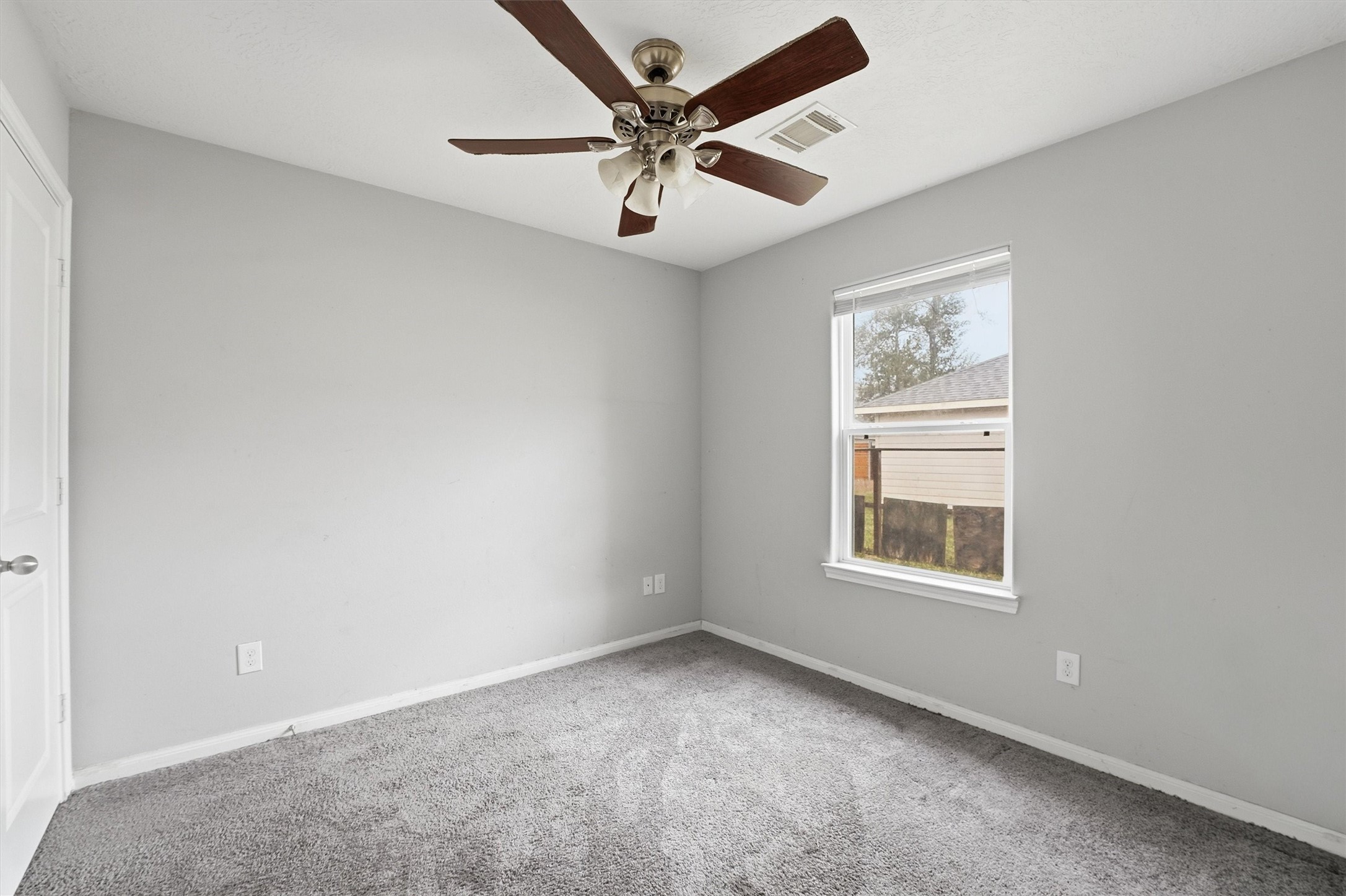 47 Road 5103 Cleveland, TX 77327 - Photo 22 of 33 an empty room with a window and a fan