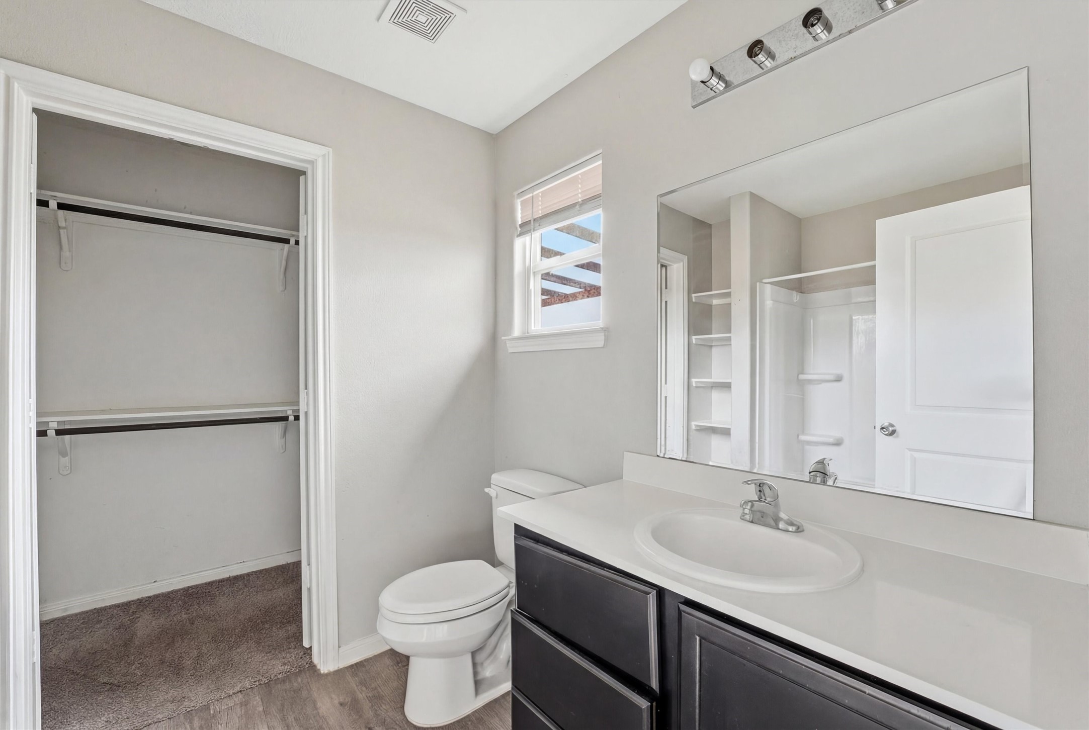 47 Road 5103 Cleveland, TX 77327 - Photo 25 of 33 a bathroom with a toilet sink vanity and mirror