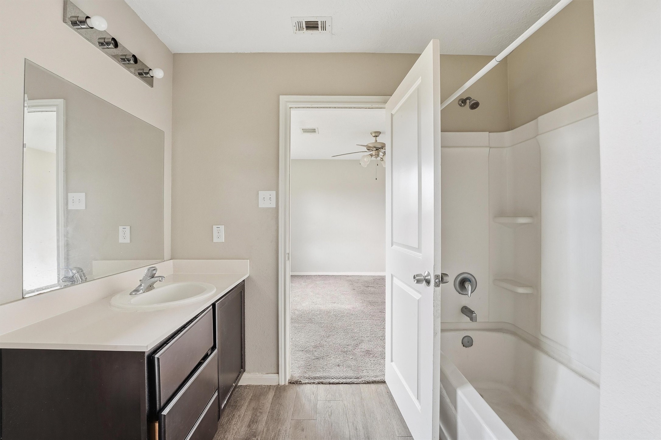 47 Road 5103 Cleveland, TX 77327 - Photo 26 of 33 a bathroom with a double vanity sink a mirror a bathtub and shower