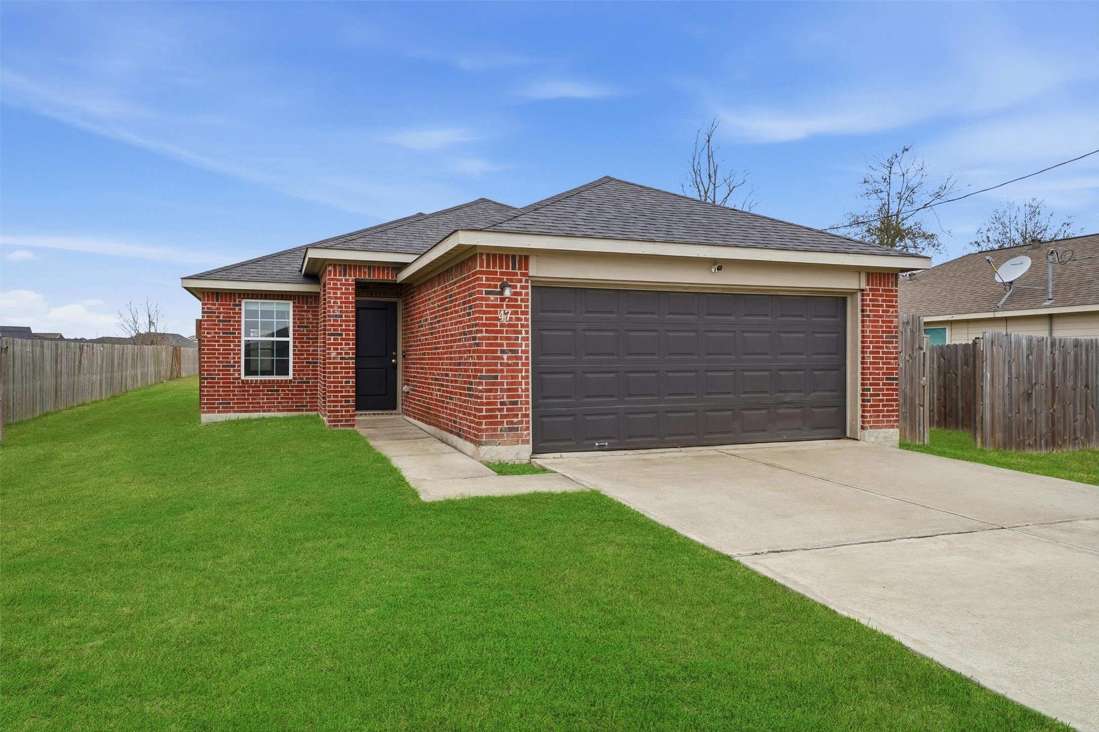 47 Road 5103 Cleveland, TX 77327 - Photo 3 of 33 a front view of a house with a yard and garage