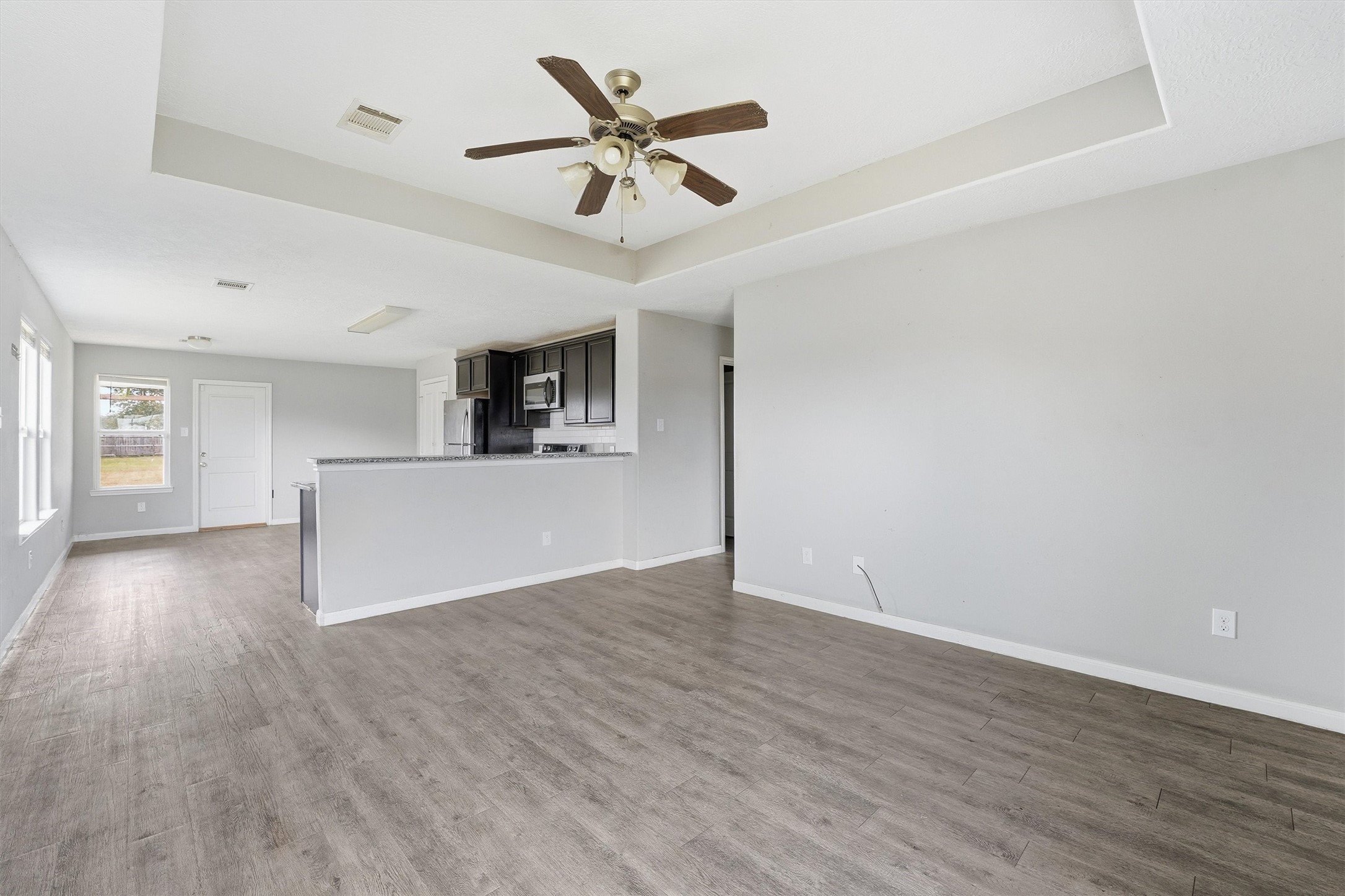 47 Road 5103 Cleveland, TX 77327 - Photo 6 of 33 a view of a livingroom with a ceiling fan wooden floor and a ceiling fan