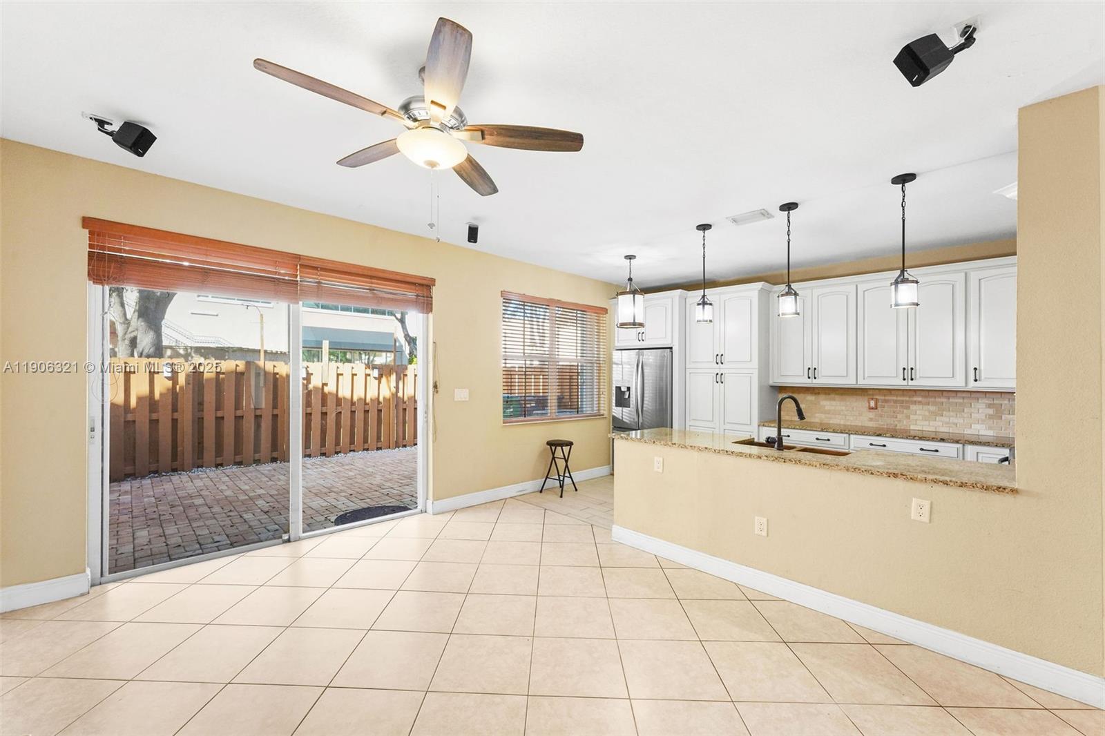 12513 Southwest 121st Way Miami, FL 33186 - Photo 11 of 37 a large kitchen with stainless steel appliances kitchen island granite countertop a sink and cabinets