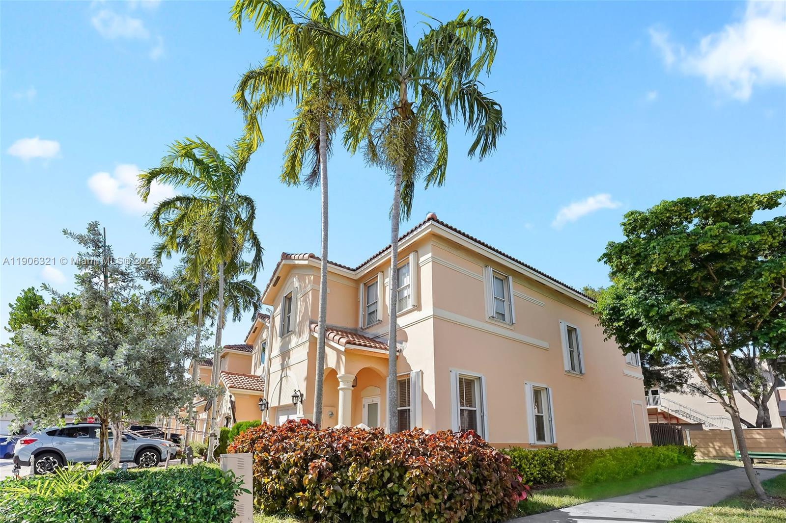12513 Southwest 121st Way Miami, FL 33186 - Photo 2 of 37 a view of a white house with a yard and potted plants
