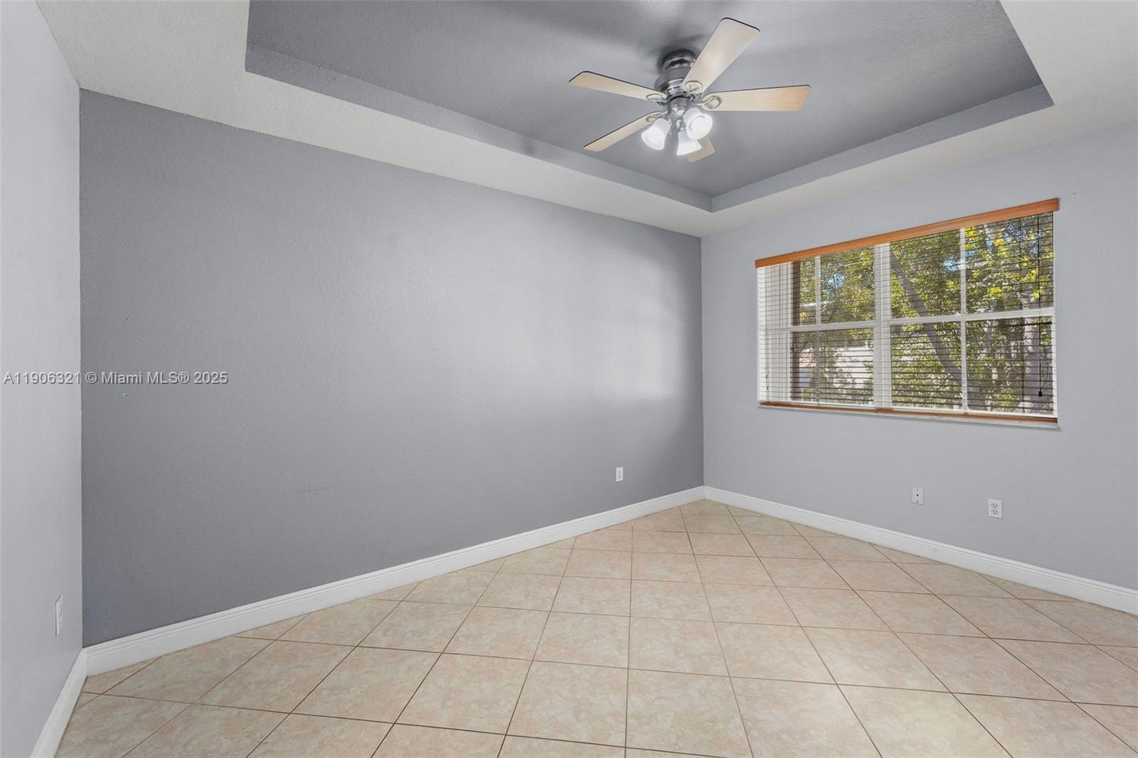 12513 Southwest 121st Way Miami, FL 33186 - Photo 22 of 37 an empty room with chandelier fan and windows