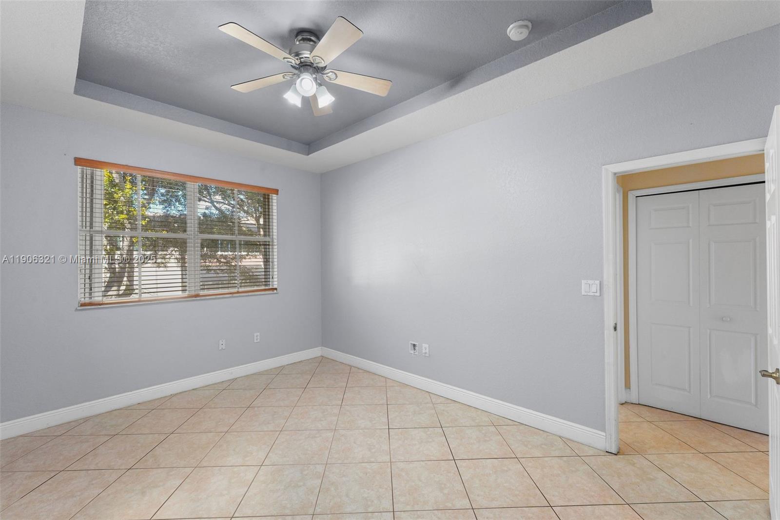 12513 Southwest 121st Way Miami, FL 33186 - Photo 23 of 37 an empty room with windows and ceiling fan