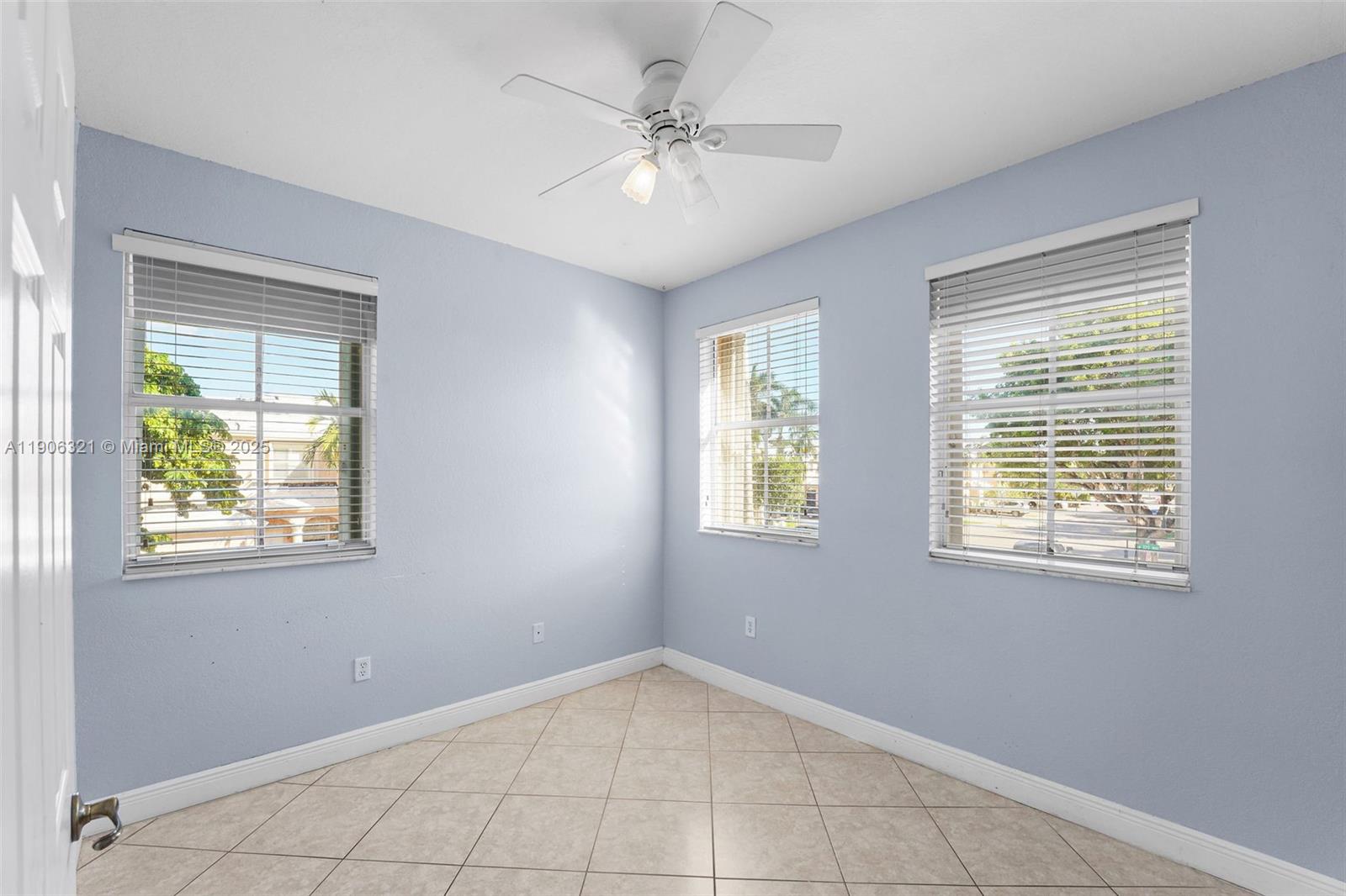 12513 Southwest 121st Way Miami, FL 33186 - Photo 27 of 37 an empty room with windows and closet