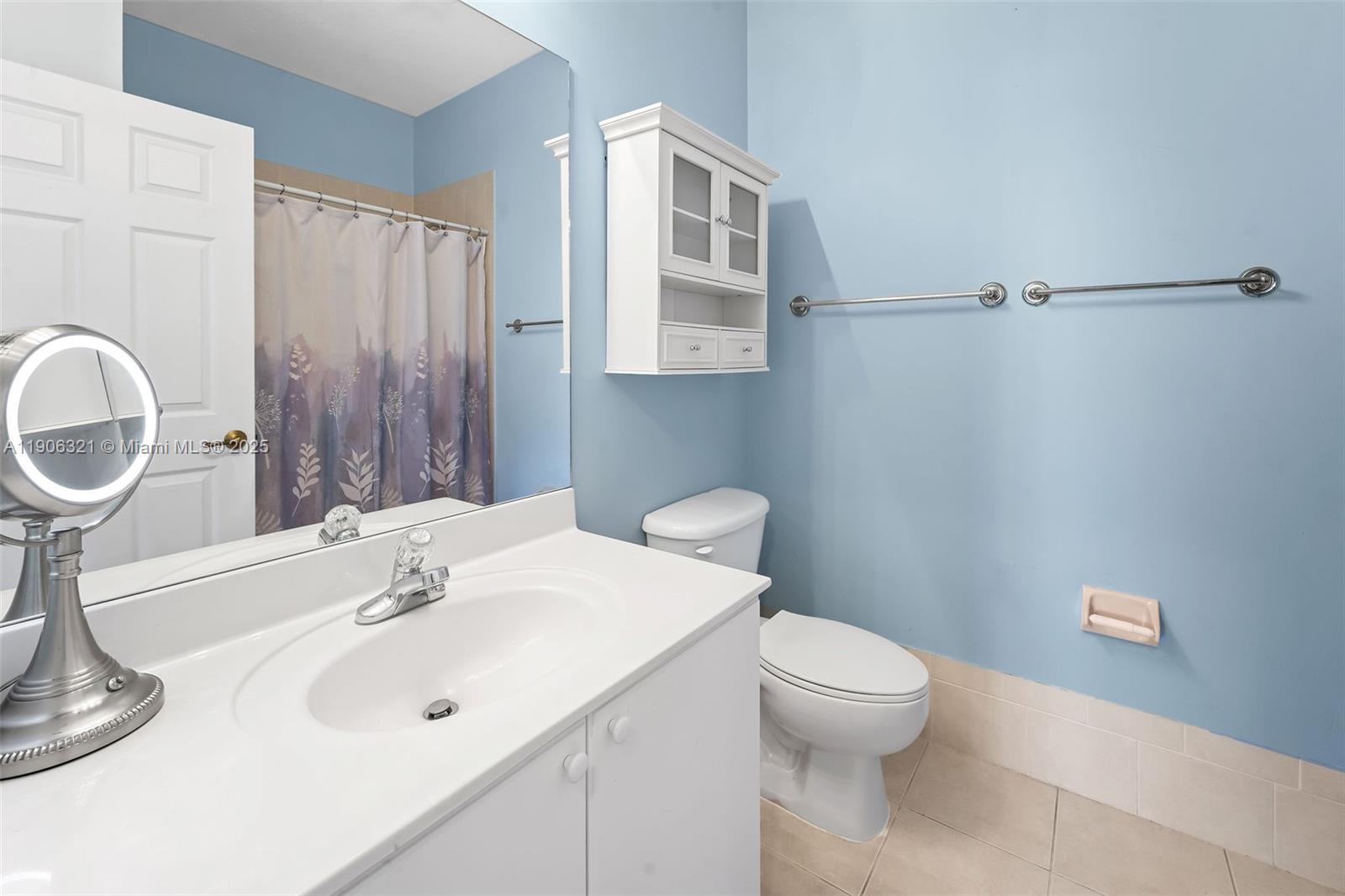 12513 Southwest 121st Way Miami, FL 33186 - Photo 29 of 37 a bathroom with a sink a toilet and a mirror