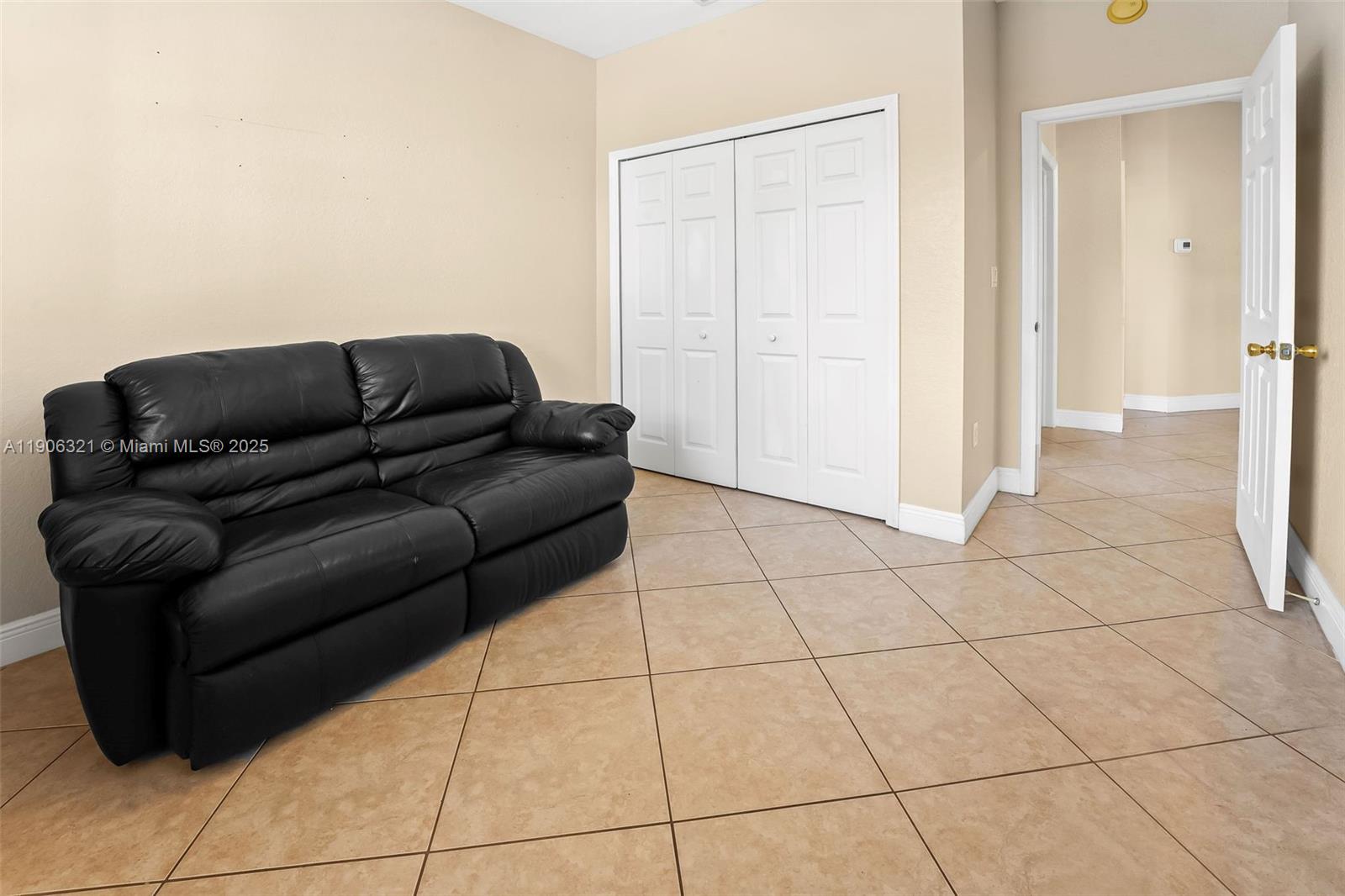 12513 Southwest 121st Way Miami, FL 33186 - Photo 33 of 37 a living room with a black white checkered floor