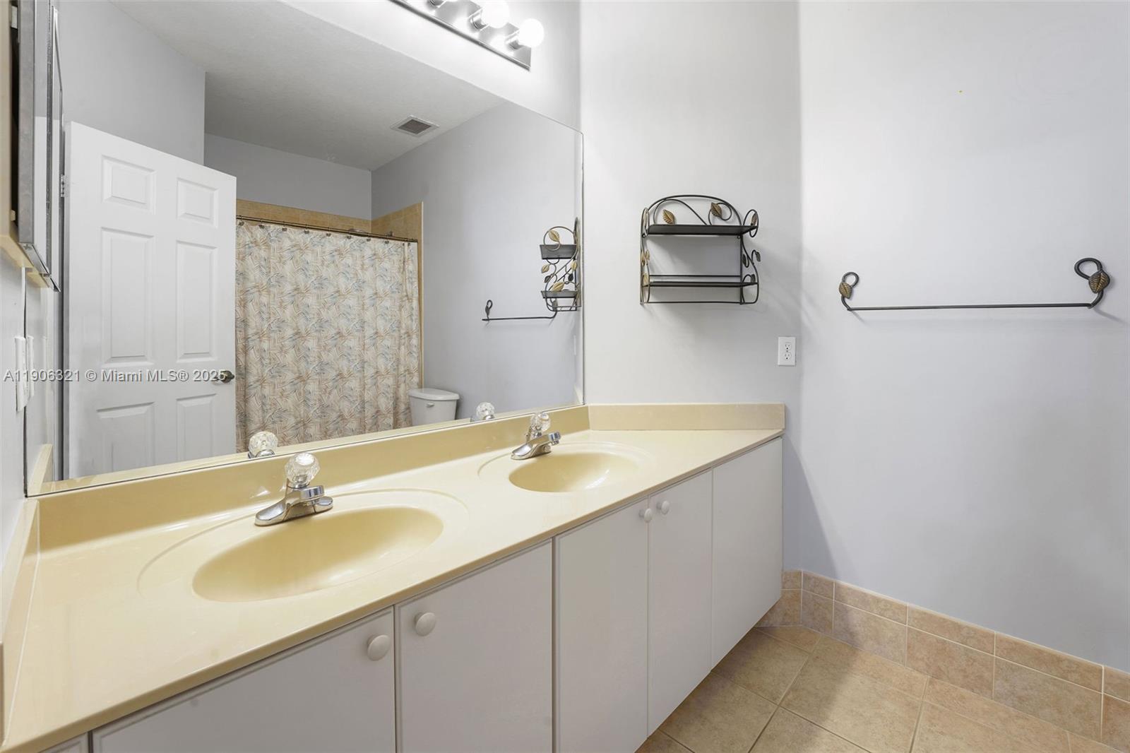 12513 Southwest 121st Way Miami, FL 33186 - Photo 37 of 37 a bathroom with a sink and a mirror