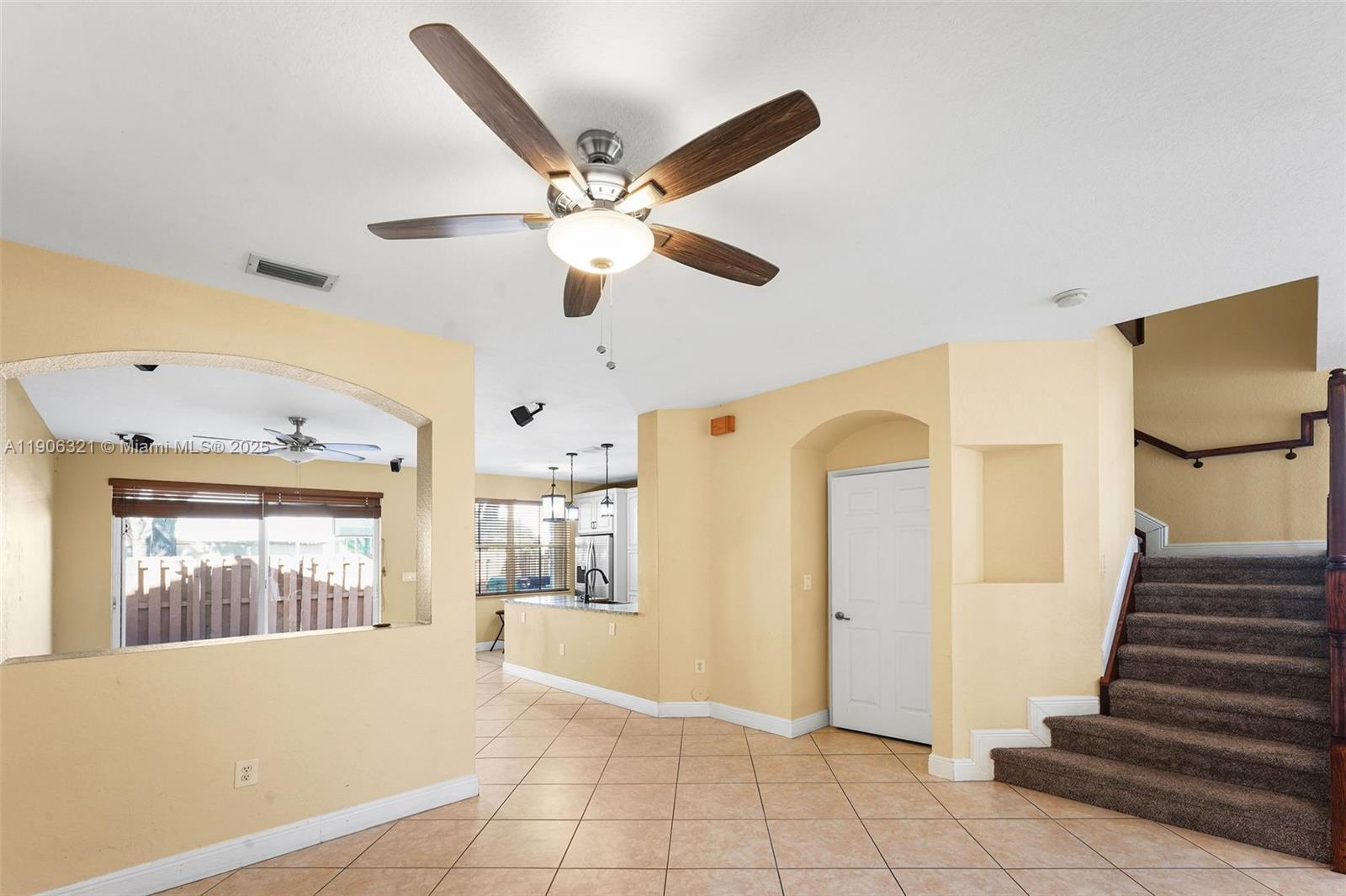 12513 Southwest 121st Way Miami, FL 33186 - Photo 4 of 37 a view of an entryway with wooden floor and a ceiling fan
