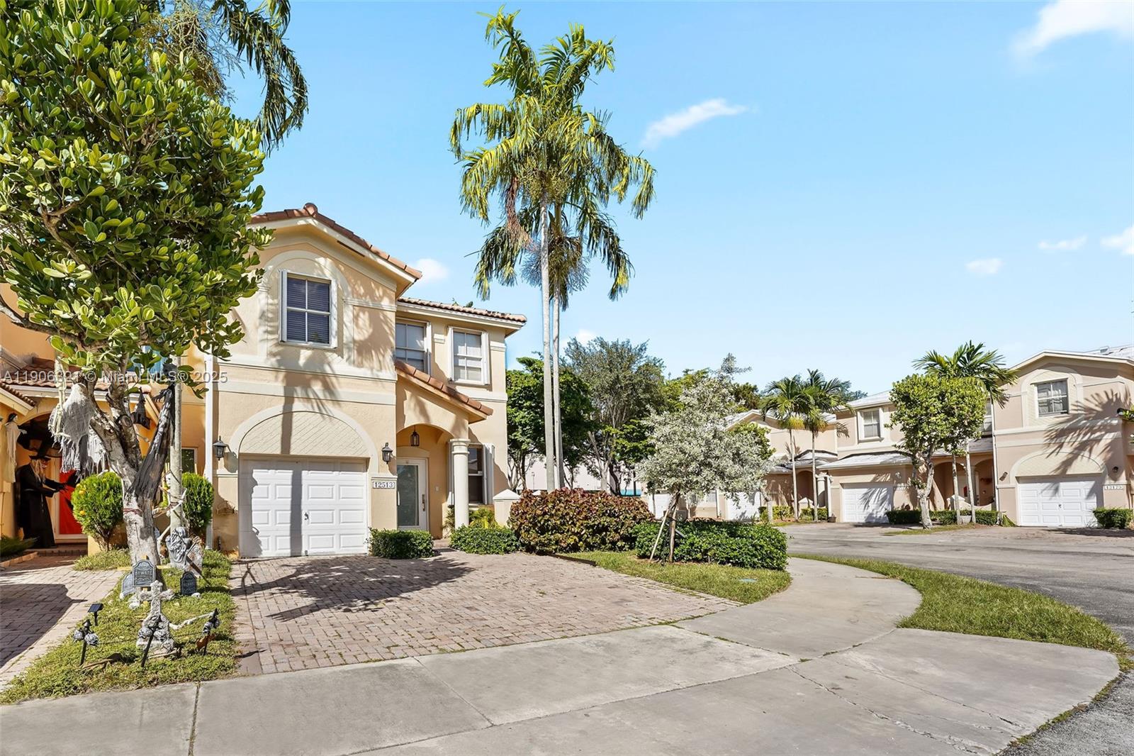 12513 Southwest 121st Way Miami, FL 33186 - Photo 9 of 37 a front view of a house with a yard and garage