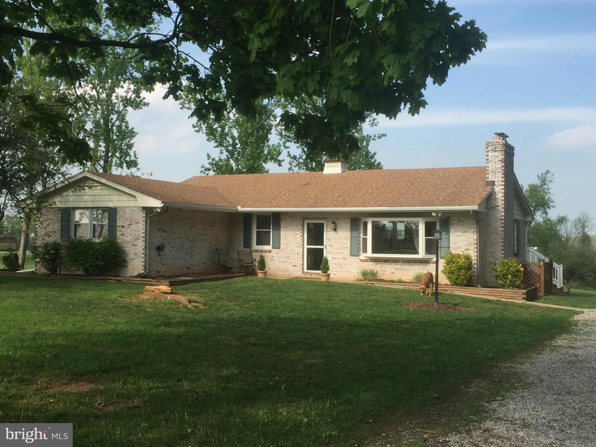 21217 Ridge Road Freeland, MD 21053 - Photo 1 of 29 a front view of a house with a garden