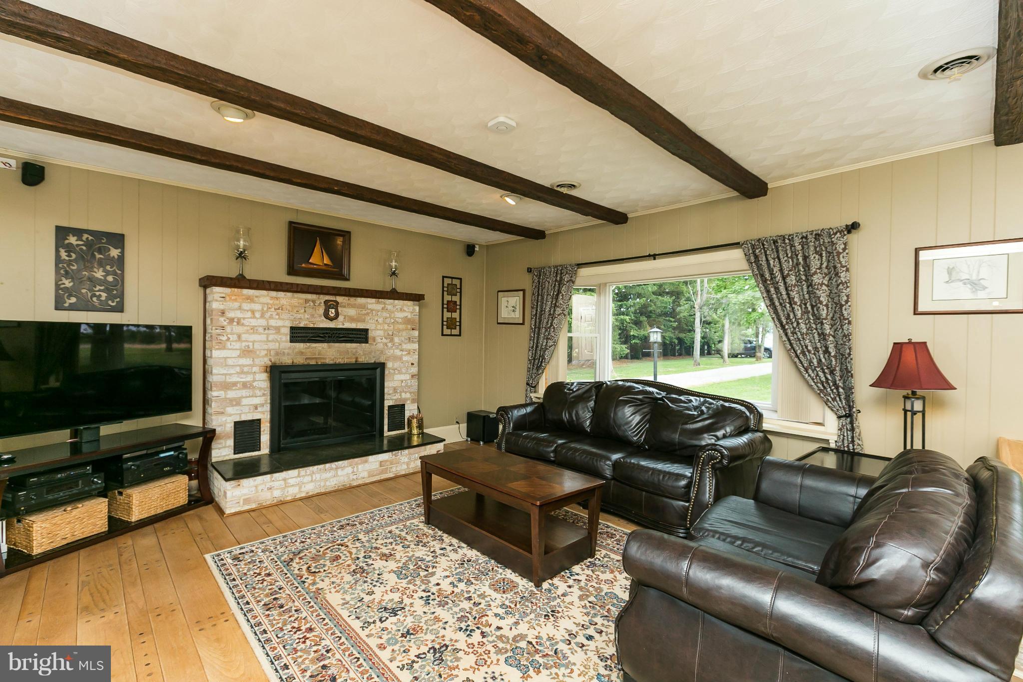 21217 Ridge Road Freeland, MD 21053 - Photo 2 of 29 a living room with furniture flat screen tv and a fireplace