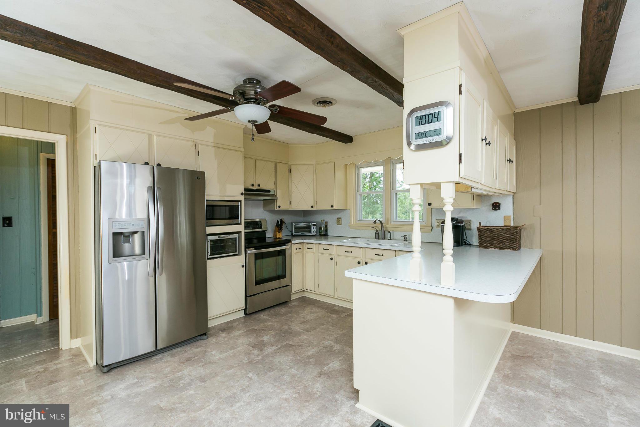 21217 Ridge Road Freeland, MD 21053 - Photo 6 of 29 a kitchen with stainless steel appliances a refrigerator sink and stove