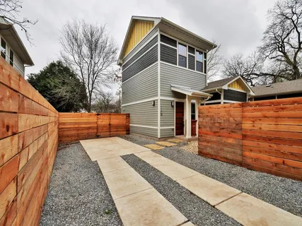 a view of a patio with table and chairs and wooden fence