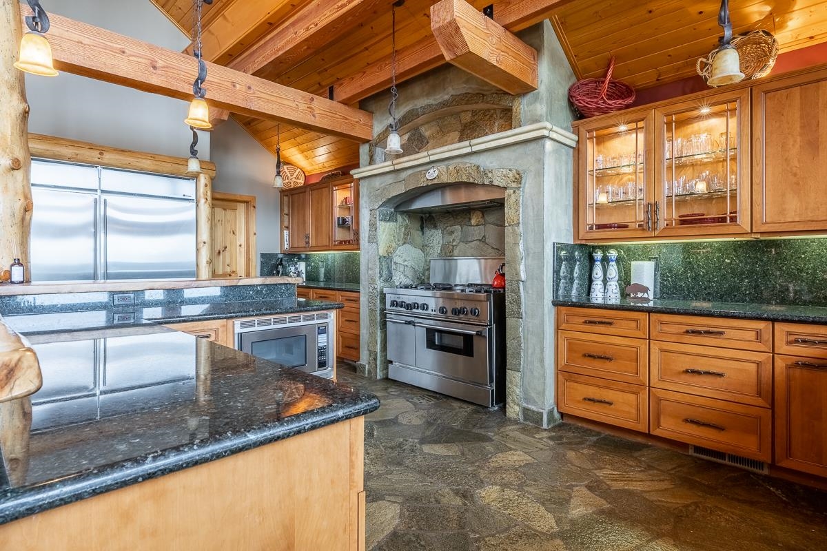 629 John Muir Road Mammoth Lakes, CA 93546 - Photo 11 of 49 a kitchen with stainless steel appliances granite countertop a sink a stove and cabinets