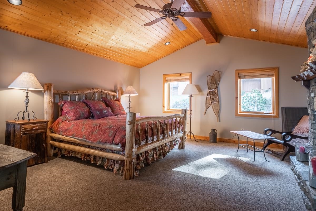 629 John Muir Road Mammoth Lakes, CA 93546 - Photo 25 of 49 a bedroom with a bed and a chandelier
