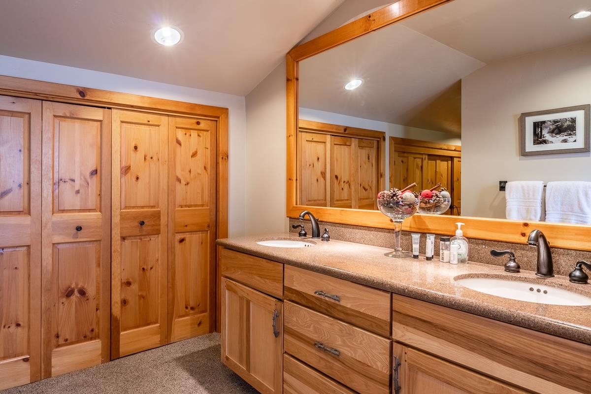 629 John Muir Road Mammoth Lakes, CA 93546 - Photo 29 of 49 a bathroom with a double vanity sink and mirror