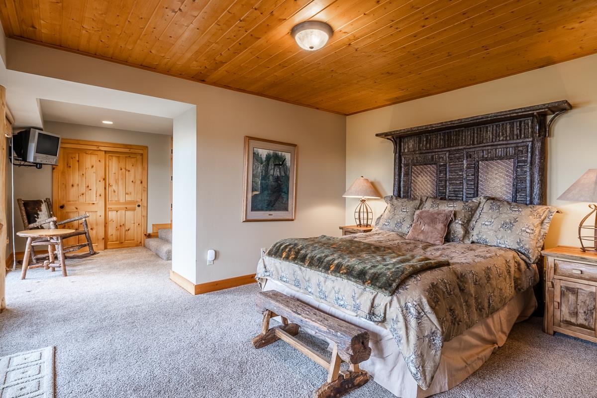 629 John Muir Road Mammoth Lakes, CA 93546 - Photo 30 of 49 a bedroom with a bed and a table