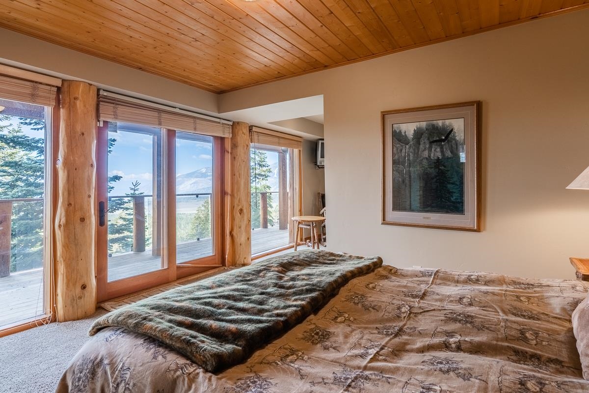 629 John Muir Road Mammoth Lakes, CA 93546 - Photo 31 of 49 a bedroom with a bed and a large window with backyard view