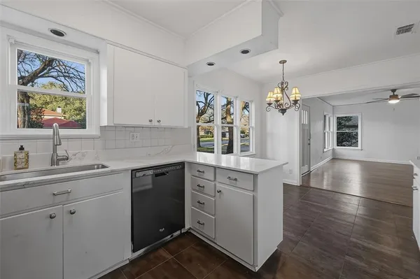 a view of a kitchen sink cabinets and wooden floor