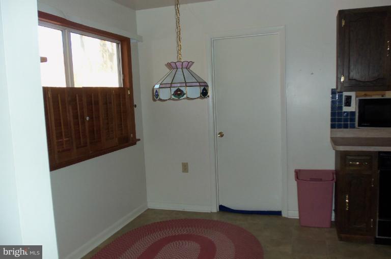 977 Grace Road Huntingtown, MD 20639 - Photo 2 of 14 a view of a storage & utility room with a window