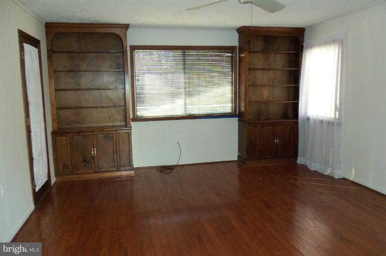 977 Grace Road Huntingtown, MD 20639 - Photo 11 of 14 an empty room with wooden floor and windows