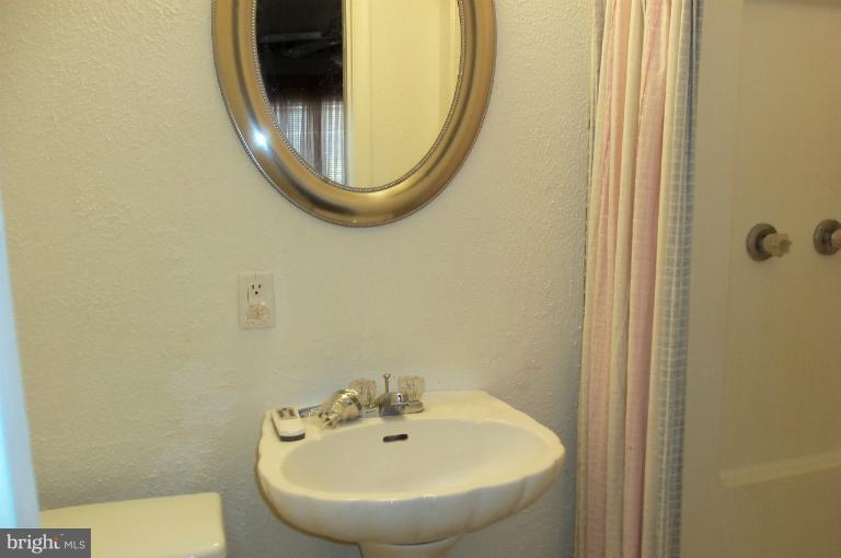 977 Grace Road Huntingtown, MD 20639 - Photo 13 of 14 a bathroom with a sink and a mirror